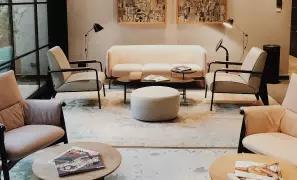 Finished living room with neutral seating and warm lighting